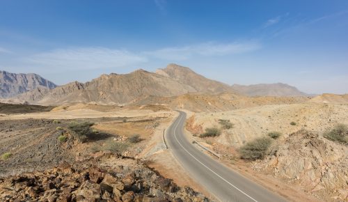 A road going thru the deserted mountains of the Sultanate of Oman