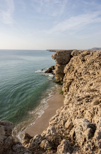 View over cliffs and Gulf of Oman at the wild coast of Ras Al Jinz, Sultantae of Oman