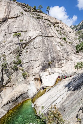 Purcaraccia Canyon in Bavella during summer, a famous tourist destination and attraction (for canyoning and hiking). You will go through clear waters with amazing natural slides. Corsica, France