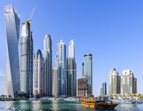 Dubai Marina Walk with CAYAN tower (1st from the left), PRINCESS Tower (5th from the left). Dubai Marina is a district in Dubai, United Arab Emirates. It is an artificial canal city, built along a two-mile (3 km) stretch of Persian Gulf shoreline. When the entire development is complete, it will accommodate more than 120,000 people in residential towers and villas.