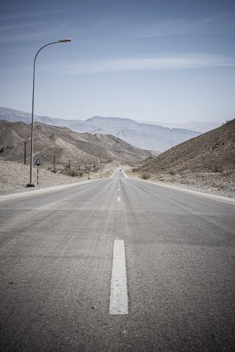 Road going thru arid mountains in Oman