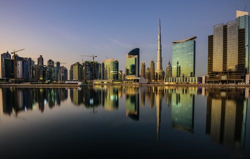 Dubai Downtown just before sunset with the buildings reflecting in the water canal. Dubai, United Arab Emirates, Middle East, Arabian Peninsula